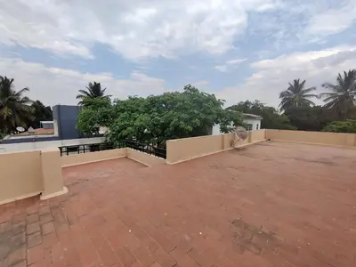 an empty roof of a house with trees at Kavitha House Homestay in Mysore