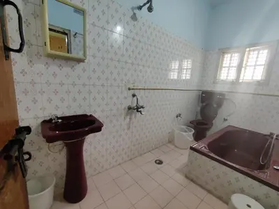a bathroom with a sink and a tub and a toilet at Kavitha House Homestay in Mysore