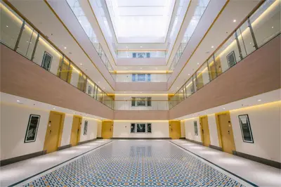 an empty hall with a skylight and a ceiling at IKON By Annapoorna in Coimbatore