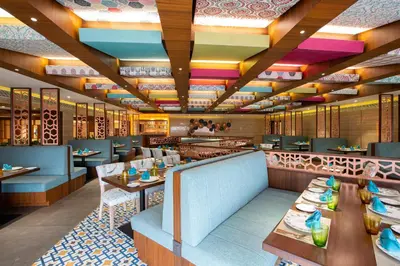a rendering of a restaurant with tables and chairs at IKON By Annapoorna in Coimbatore