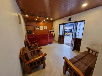 a waiting room with a couch and chairs in a building at Royal Mist in Ooty