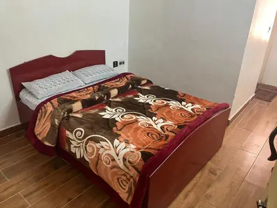 a bed in a room with a wooden floor at Royal Mist in Ooty