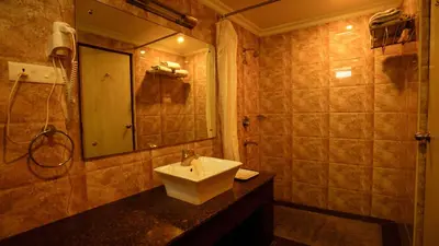 a bathroom with a sink and a mirror at National Residency in Mysore
