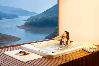 a woman sitting in a bath tub with a view at MOUNTAIN SHADOWS RESORT Wayanad in Wayanad