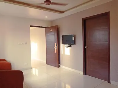 a room with a door and a television on the wall at HOTEL VINTAGE CASTLE in Coimbatore