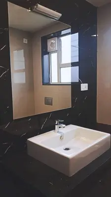 a bathroom with a white sink and a mirror at HOTEL VINTAGE CASTLE in Coimbatore