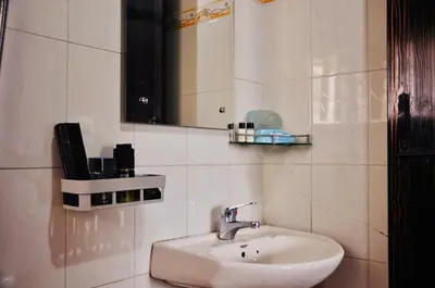 a bathroom with a sink and a mirror at Little House Ooty in Ooty