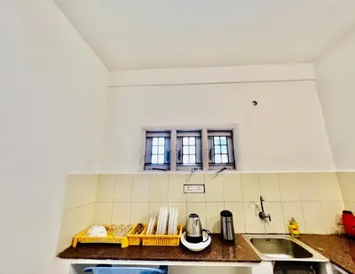 a kitchen with a sink and a window at Little House Ooty in Ooty
