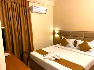 a hotel room with a bed with a flower on it at TAG HOTELS in Irugūr