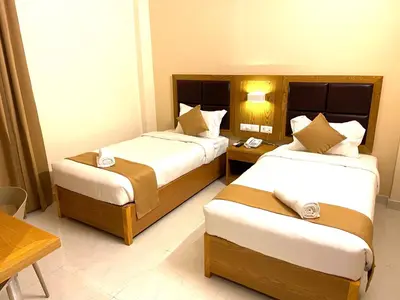a hotel room with two beds and a table at TAG HOTELS in Irugūr