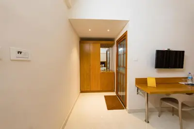 a kitchen and dining room with a wooden table at TAG HOTELS in Irugūr