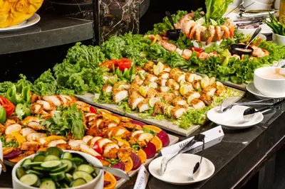a buffet filled with lots of different types of food at Fezinn Hotel - Best Wayanad Hotel in 2024 in Kozhikode