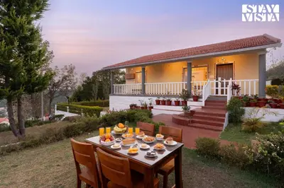 a table in front of a house at StayVista at Zolas Retreat 2BHK Pet Friendly and Breakfast Included in Coonoor