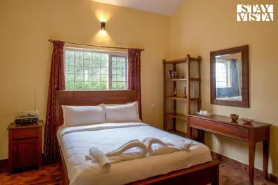 a bedroom with a bed with a statue of a woman on it at StayVista at Zolas Retreat 2BHK Pet Friendly and Breakfast Included in Coonoor
