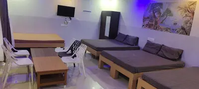 a room with four beds and a table and chairs at C M HOTEL NEW in Wodapatti