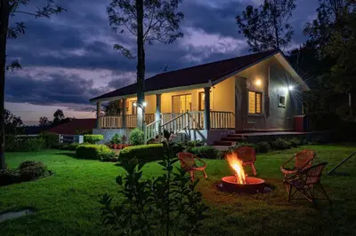a house with a fire in the yard at night at StayVista at Casa Pinnacle - Pet Friendly Home with Lawn in Coonoor