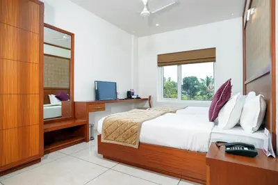 a bedroom with a bed and a sink and a mirror at Nexstay River Mouth International in Ferokh