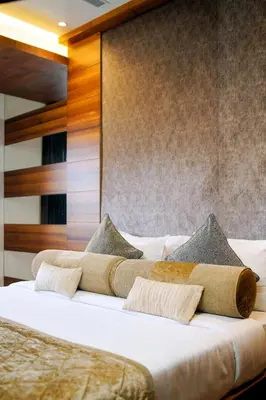 two beds in a hotel room with towels on them at Nexstay River Mouth International in Ferokh