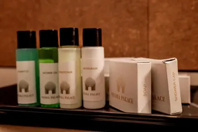 a group of four bottles of hair products on a shelf at Nesma Palace in Kannur