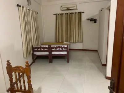a room with a bench and a window with curtains at Jinan city centre in Alwaye