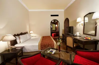 a hotel room with a bed and a desk at The Gateway Hotel Beach Road, Calicut in Kozhikode