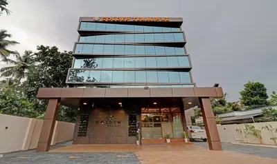 a tall building with a sign on top of it at Treebo Golden Terminal Kochi Airport With Swimming Pool in Cochin