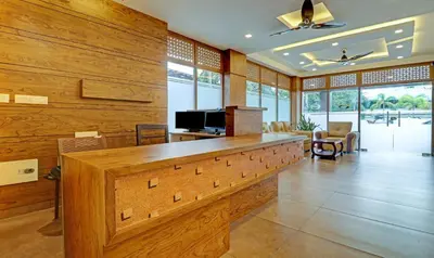 a large living room with a wooden wall at Treebo Golden Terminal Kochi Airport With Swimming Pool in Cochin