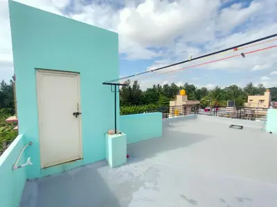 a white door on the roof of a blue building at Akshay Sweet Home Stay in Mysore