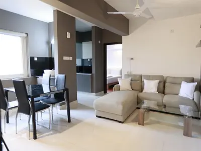 a living room with a couch and a table at Transit Suites by GrandWest in Nedumbassery