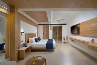 a hotel room with a bed and a tv at Lago Leisure Resort & Spa in Cherai Beach