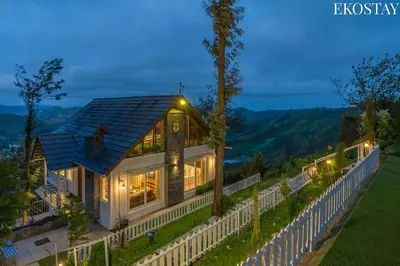 a house with lights on the side of it at EKO STAY - Woodside Ivy in Ooty