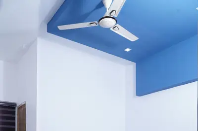 a ceiling fan in a room with a blue ceiling at THEKKUMPURAM RESIDENCY in Kondotti