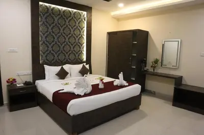 a bedroom with a large bed with towels on it at Royal Destiny Resort in Malaiyāndipattanam