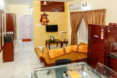 a living room with a couch and a tv at Belljem Homes -your own private resort -1 BHK FF in Trichūr