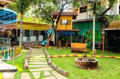 a park with a playground with a slide and a building at Belljem Homes -your own private resort -1 BHK FF in Trichūr