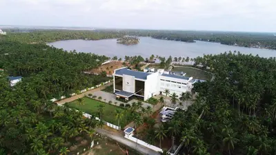 an aerial view of a building next to a river at Blue Serene Backwater Resort in Guruvāyūr