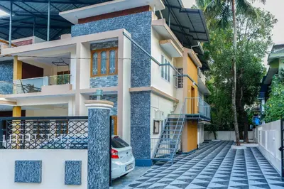 a house with a blue and white facade at Belljem Homes -your own private resort -4 BHK FF in Trichūr