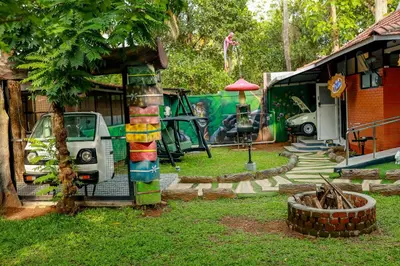 a yard with a car parked next to a house at Belljem Homes -your own private resort -4 BHK FF in Trichūr