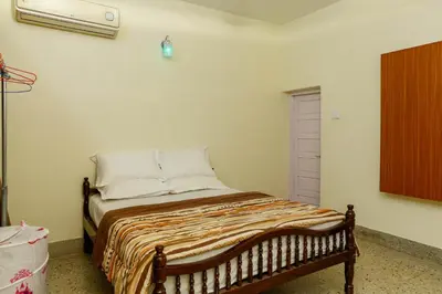 a small bed in a room with at Belljem Homes -your own private resort -4 BHK FF in Trichūr