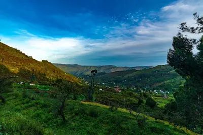 a view of a valley with mountains in the background at Warmth Hill Crest in Kodaikānāl