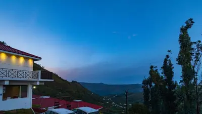 a building with lights on the side of it at night at Warmth Hill Crest in Kodaikānāl