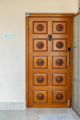 a wooden chest of drawers in a room at Belljem Homes -your own private resort -6 BHK S in Trichūr