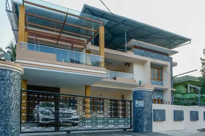 a house with a balcony with a fence at Belljem Homes -your own private resort -6 BHK S in Trichūr