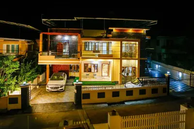 a house with a car in front of it at night at Belljem Homes -your own private resort -6 BHK S in Trichūr
