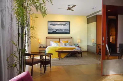 a hotel room with a bed and a table at Saptha Resort and Spa in Sultan Bathery