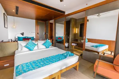 a bedroom with a large bed and a bathroom at Saptha Resort and Spa in Sultan Bathery