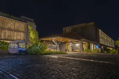 a small vehicle parked in front of a building at night at Saptha Resort and Spa in Sultan Bathery