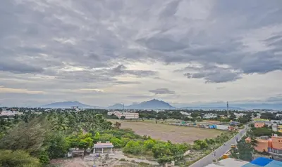 a view of a city with mountains in the background at Treebo Everest Residency Tidel Park, 15 Mins From Coimbatore International Airport in Coimbatore