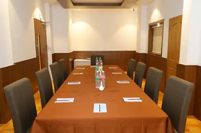 a conference room with a long table with chairs at HOTEL LA SERENE Mattannur in Mattanūr