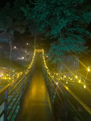 a bridge with lights on it at night at Casa Lucio Resorts in Mannārakkāt